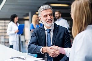 Doctors shaking hands with medical patent professional