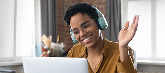 Woman smiling while working on Laptop in Office