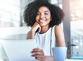 smiling woman sitting holding a notebook